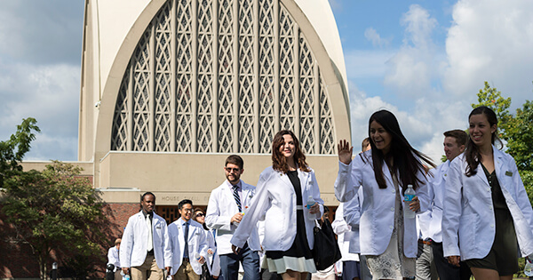 First year med students assemble for a photo on the quad steps after the ceremony.