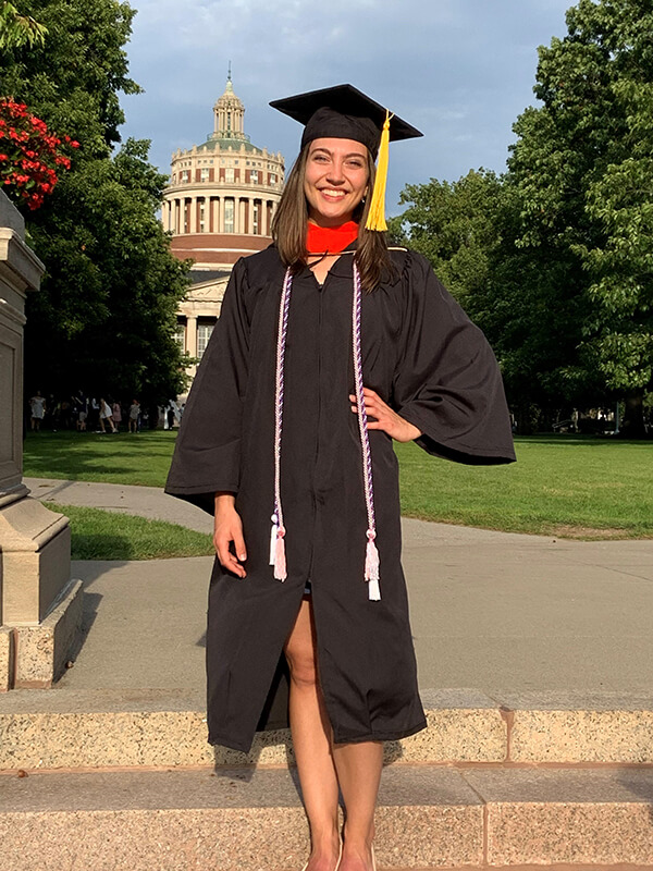 Amanda Tatem poses for a photo outdoors in her cap and gown