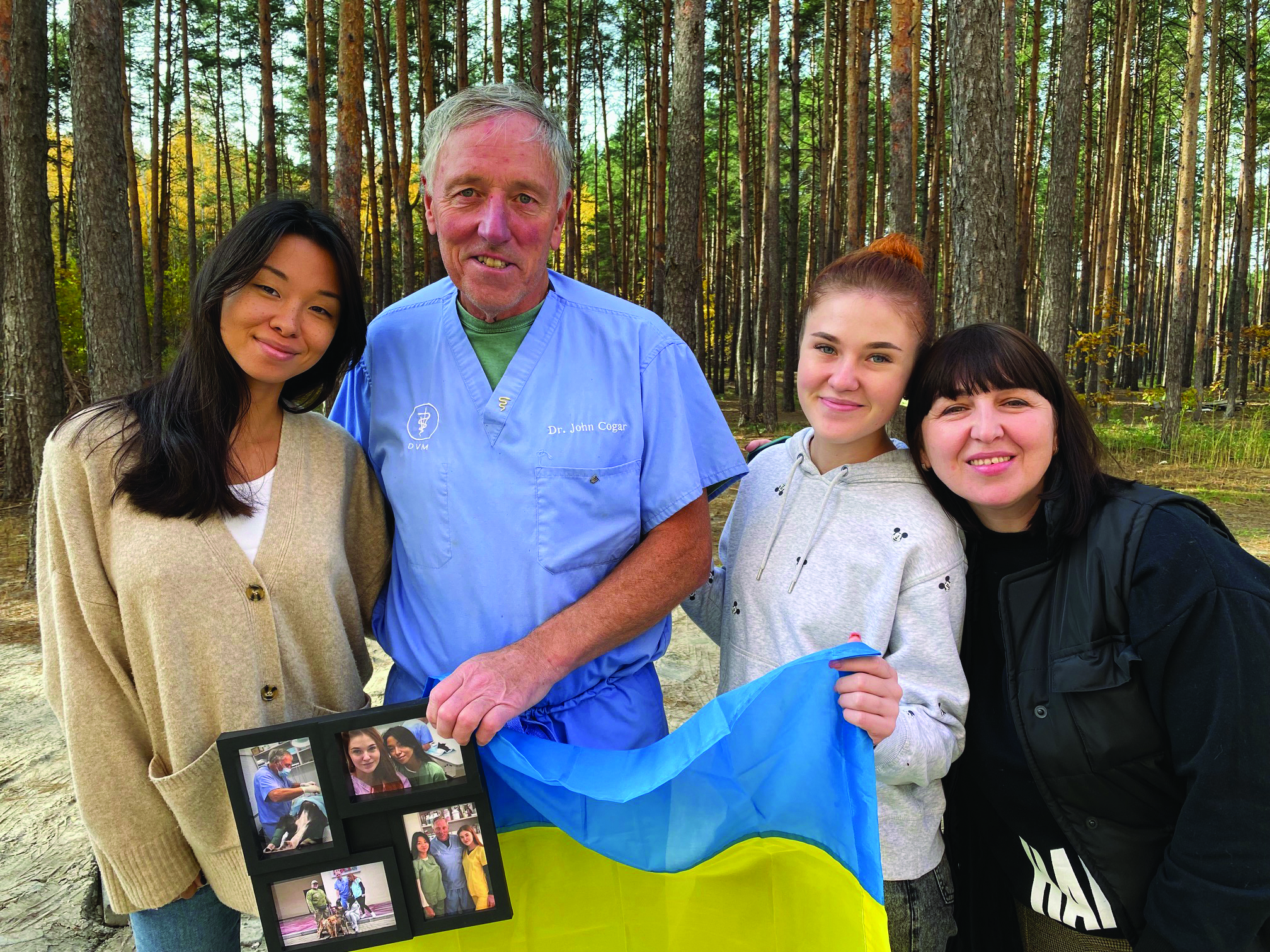 STAFF SUPPORT: The staff of a Ukrainian clinic presented Cogar with a flag to thank him for his service treating abandoned dogs and cats as a volunteer veterinarian near the capital of Kyiv.