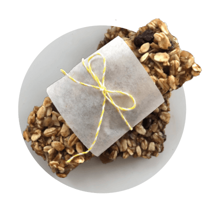 a gluten-free oat bar wrapped in paper with a yellow and white string tying it