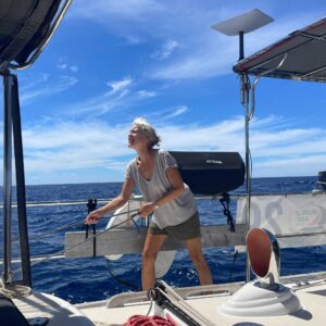 Jill seen holding a rope, looking upwards while on a boat