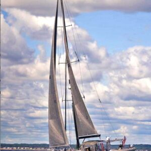 sailboat on water in front of a cloudy sky