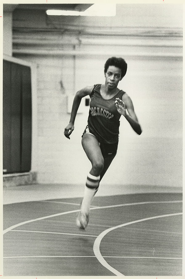 A younger Jackie Blackett ’81 running on a track.