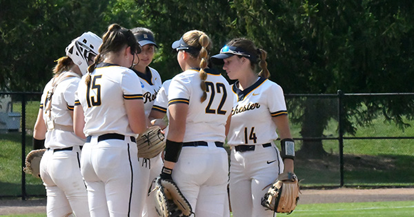 Group of UR softball players huddling