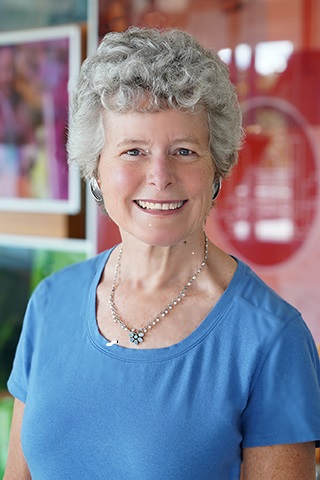 headshot of Jane Tuttle, PhD, ’79N, ’84N (MS), seen in blue top