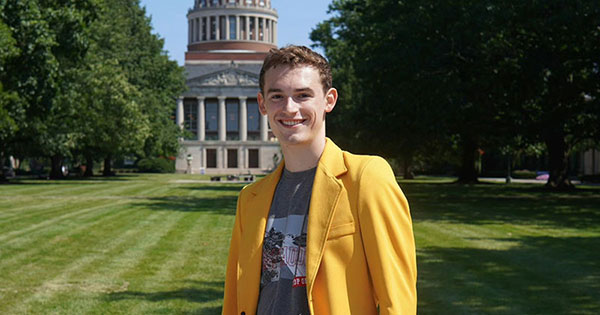Ethan R. King ’27 in front of a University of Rochester building on River Campus.