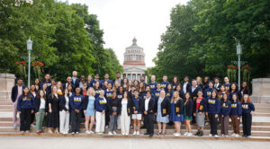 Current and former Student Alumni Ambassadors (SAA) gathered on the Eastman Quad steps.