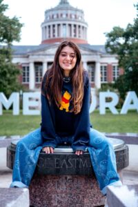 Celia Konowe ’21, T5’22 in front of Rush Rhees library with Meliora letters in the background