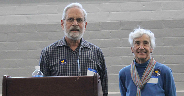 Dick and Vicki Schwartz standing behind a lecturn