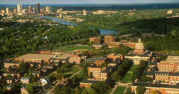 Aerial view of river campus, with the genesee river and Rochester skyline.