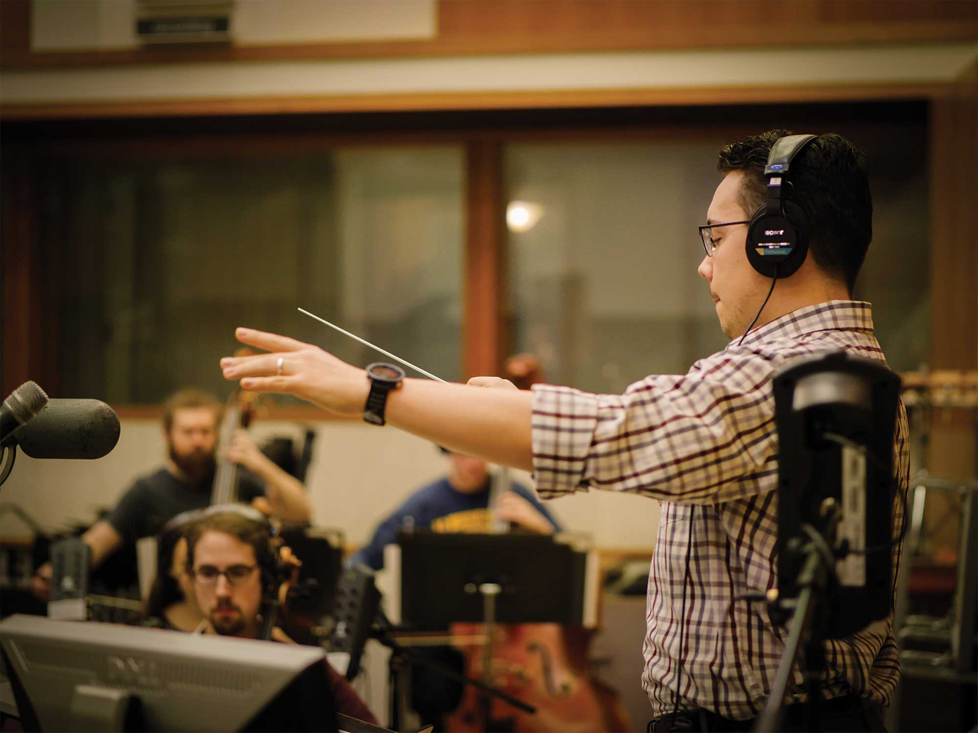 conductor working in front of his orchestra
