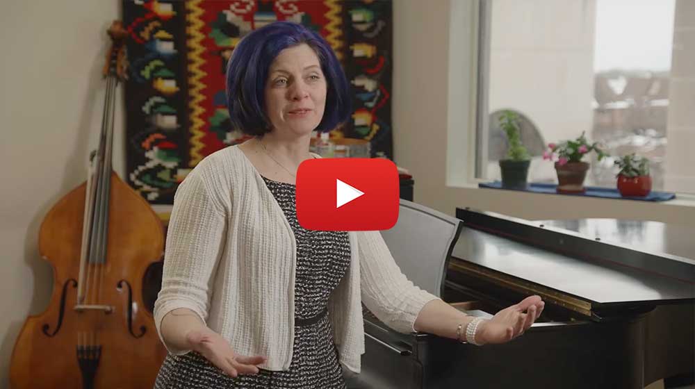 gaelen mccormick standing in front of piano being interviewed