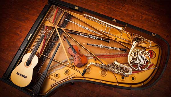piano from the top opened with instruments laid out within it