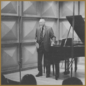 man standing at piano on stage