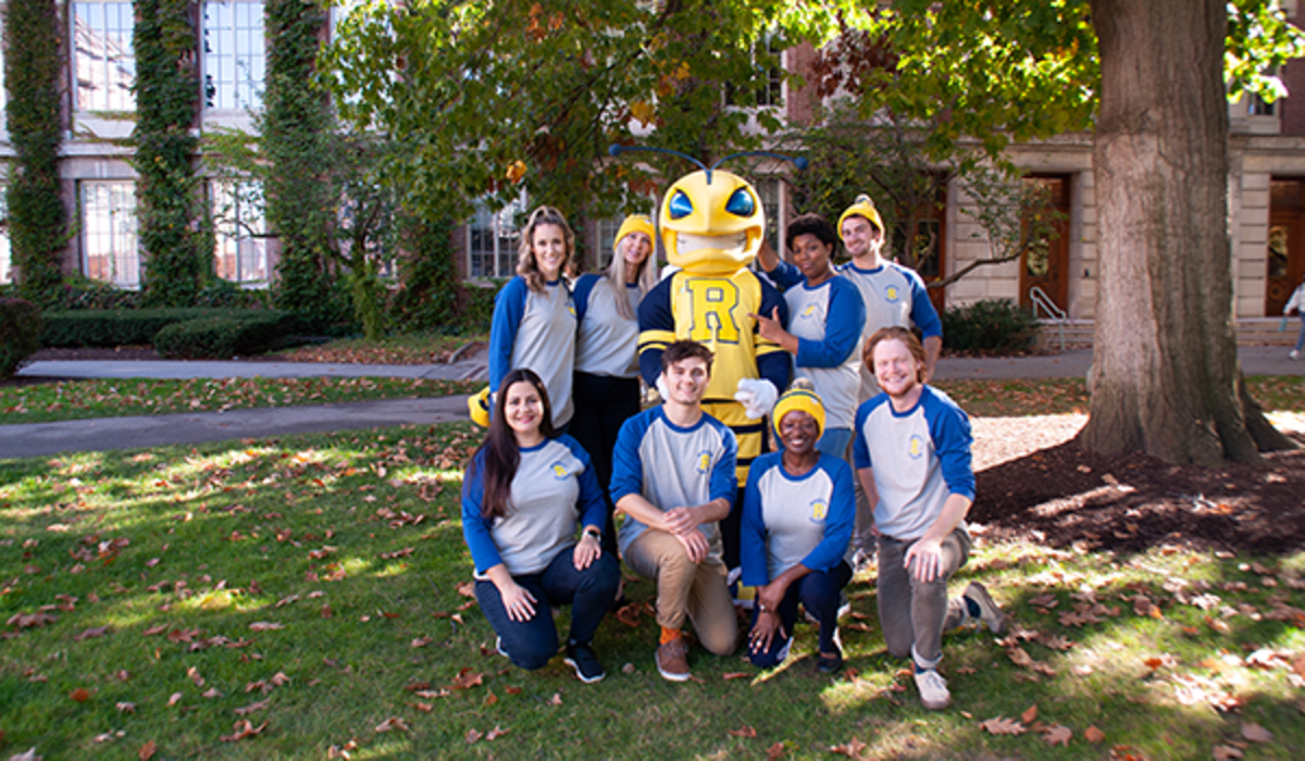 Students and Rocky pose outside in Comfy for a Cause garb