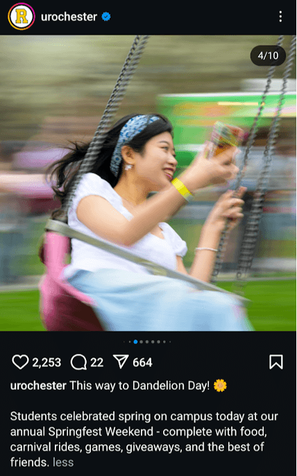 A young woman smiles joyfully while riding a carnival swing at the University of Rochester’s Springfest Weekend celebration.