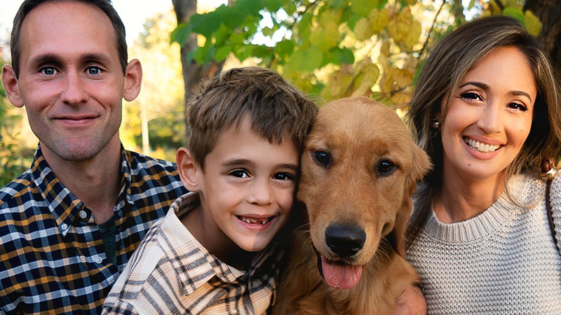 Jessica Driffill, husband, son and dog posing for a family picture
