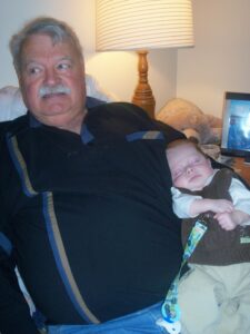David Beatson holding his grandson