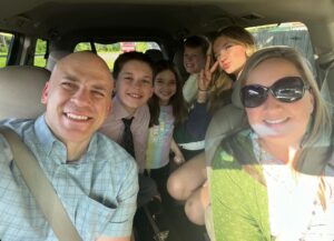A group photo of a family in a car
