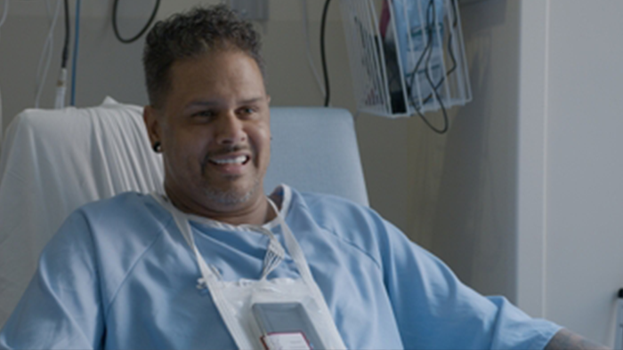 Shane Pitts in a hospital and hospital gown