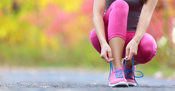 Woman runner tying her sneakers