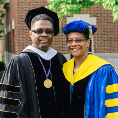 Lisa Norwood posing with a man both in cap and gown
