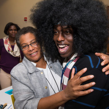 Lisa Norwood posing with a student both with smiles on their faces