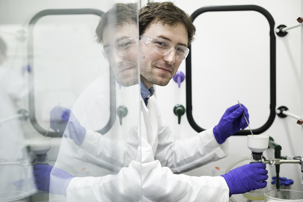 Take Five student Austin Bailey is pictured in the lab of chemistry professor Todd D. Krauss August 4, 2017. Bailey is working on synthesizing a proprietary polymer to be used to bring carbon nanotubes into organic solution. Carbon nanotubes are thin sheets of carbon — like graphene — but rolled into a nanometer sized cylinder. This polymer will have chemically reactive groups that will permit the attachment of other molecules to the nanotube very easily — some molecules that will harvest sunlight and turn them into charges and some molecules that will take those charges and make hydrogen from water — allowing for strong renewable energy applications.