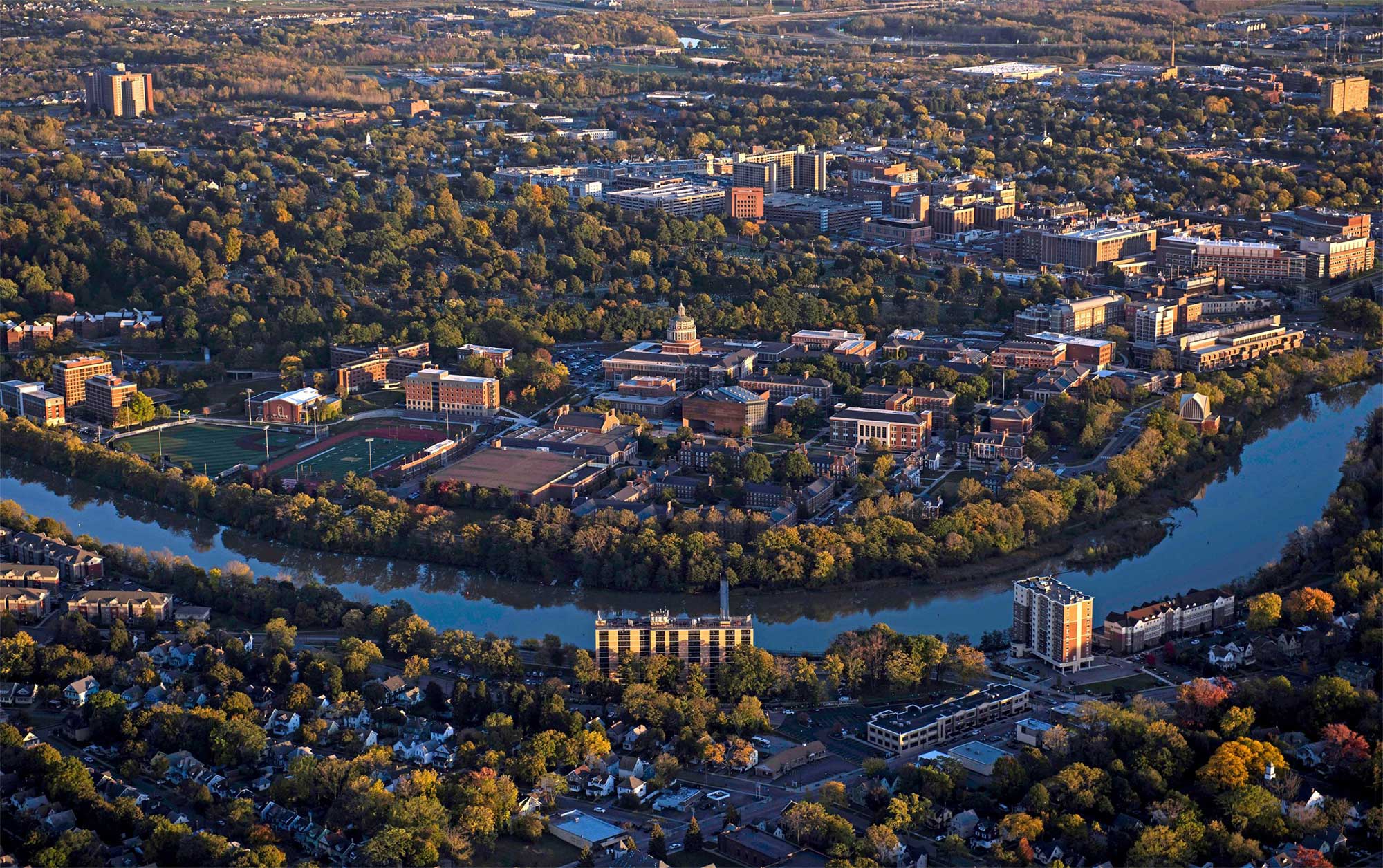 aerial image of the river campus with genesee river in front and medical center in background