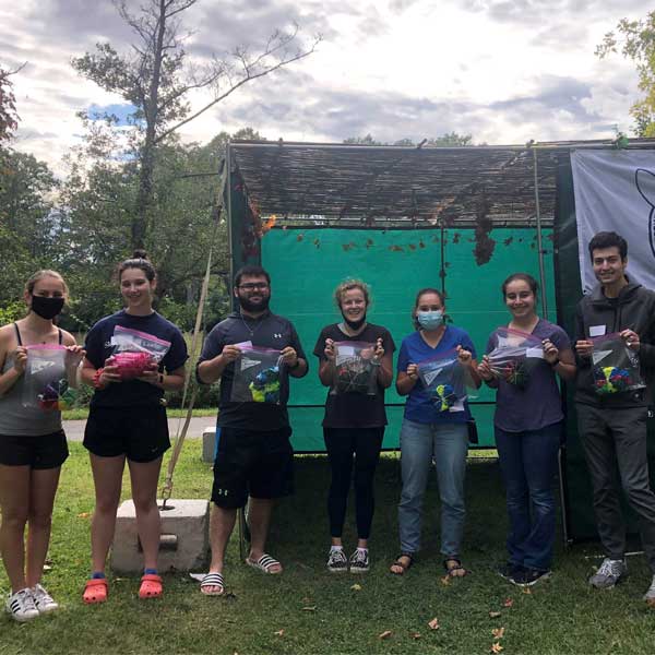 students holding tie-dyed shirts