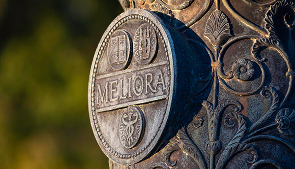 meliora symbol engraved on a statue