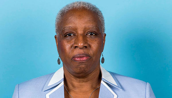 Jackie Blackett ’81 posing wearing a light blue blazer