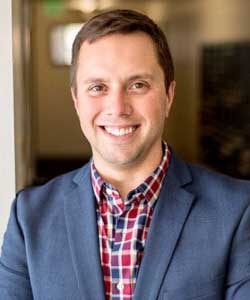 Jason Smith portrait in plaid shirt with blue blazer