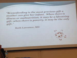 A quote from Dr. Lawrence displayed on a monitor during a presentation.