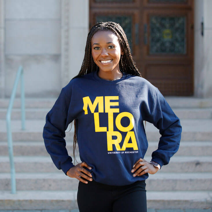 Student wearing a crewneck Rochester sweatshirt