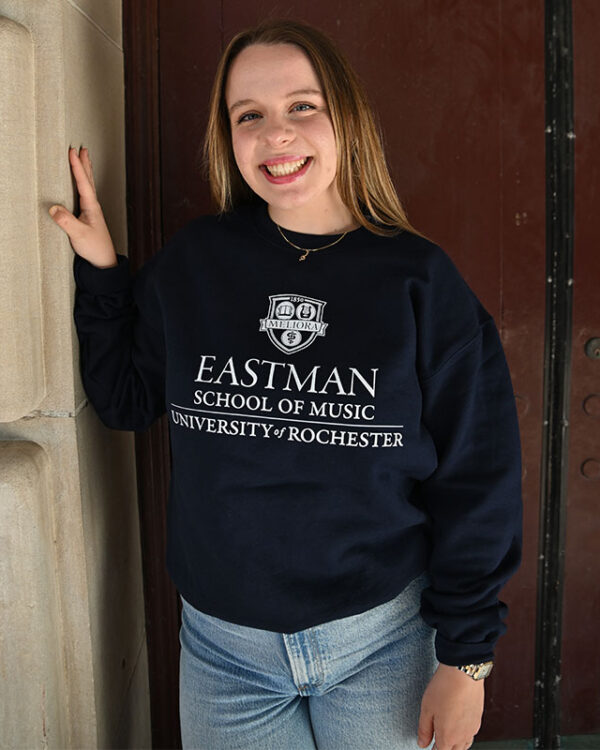 Student wearing a Eastman School of music crewneck sweatshirt