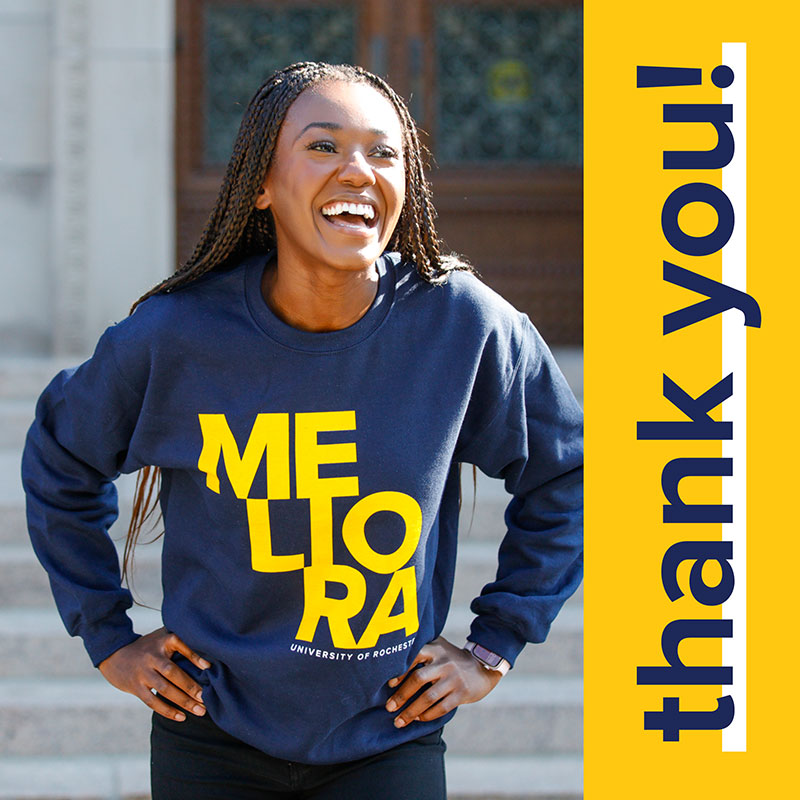 Student wearing a crewneck Rochester sweatshirt with the words thank you! written on the side. 
