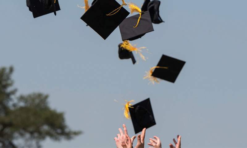 Graduation caps being thrown into the air