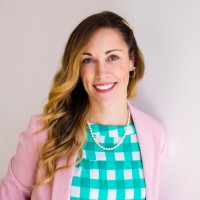 Rose Cooper '10S(MBA) in pink jacket and teal plaid shirt