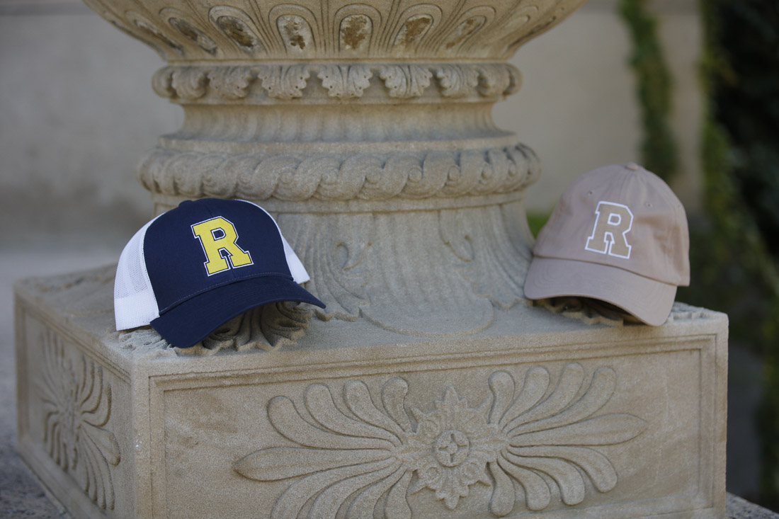 2 baseball cops with Univ. of Rochester "R" logo on it, sitting on a column