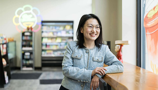 Yaofang (Vicki) Liang smiles and looks out the window of JoyMart, the Asian grocery store and cafe she founded and runs.
