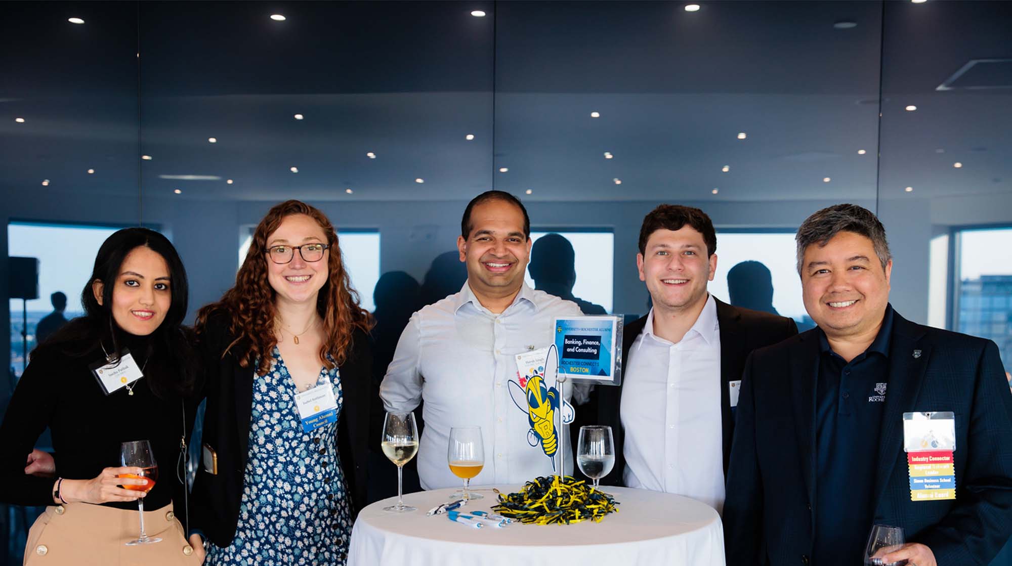 two women and three men posing for photo a networking event