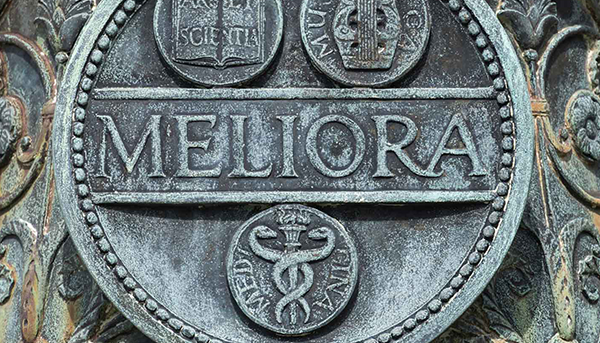 Meliora sigil carved into stone