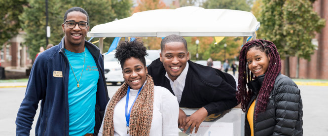 students on campus smiling for the camera