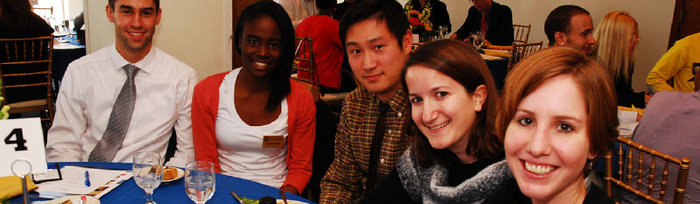 5 people sitting and posing for camera