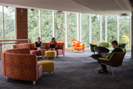Rettner Hall lounge area with students on furniture
