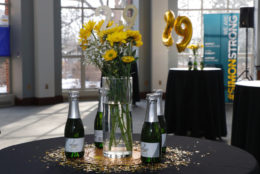yellow flowers on table with bottles of champagne