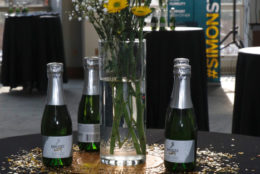 yellow flowers on table with bottles of champagne