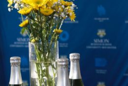 yellow flowers on table with bottles of champagne