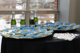 bottles in background and blue cookies with yellow 29 on them in foreground